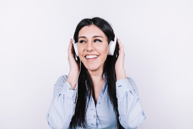 Free photo cheerful woman listening to music