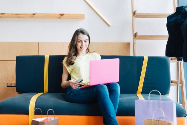 Cheerful woman making online purchases