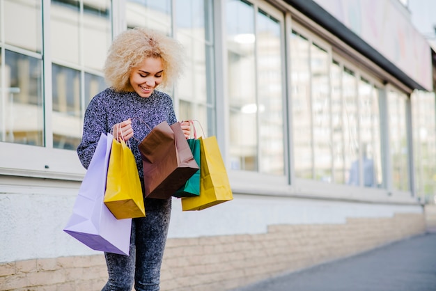 Free photo cheerful woman opening paper bag