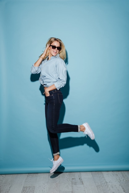 Cheerful woman in shirt and sunglasses