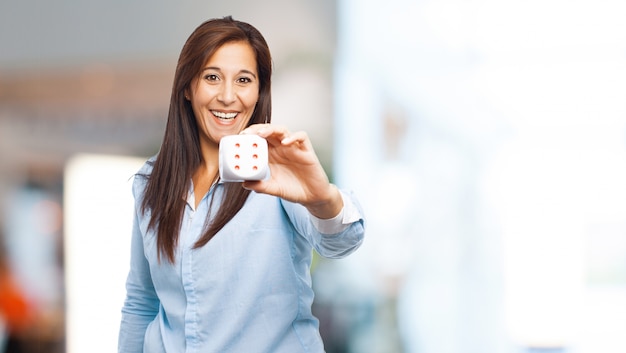 Cheerful woman showing a dice