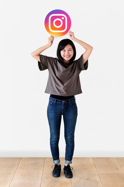 cheerful woman showing an instagram icon