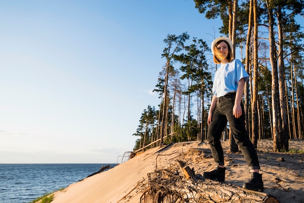 Cheerful woman standing near sea