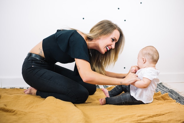 Cheerful woman talking to baby