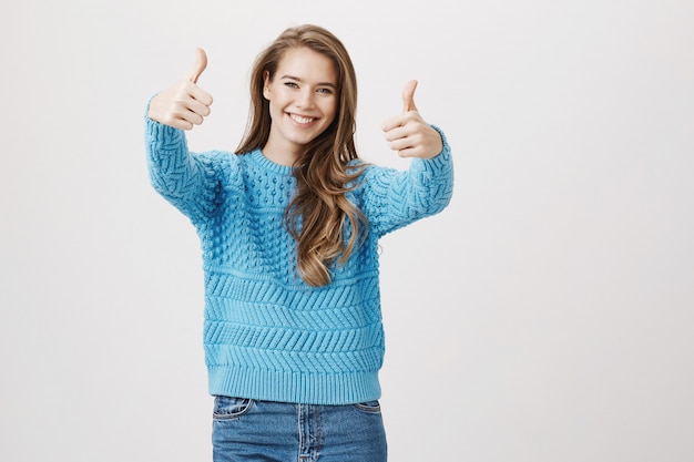 Cheerful woman thumb-up in approval, like idea