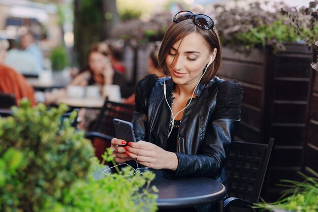 Cheerful woman using her mobile