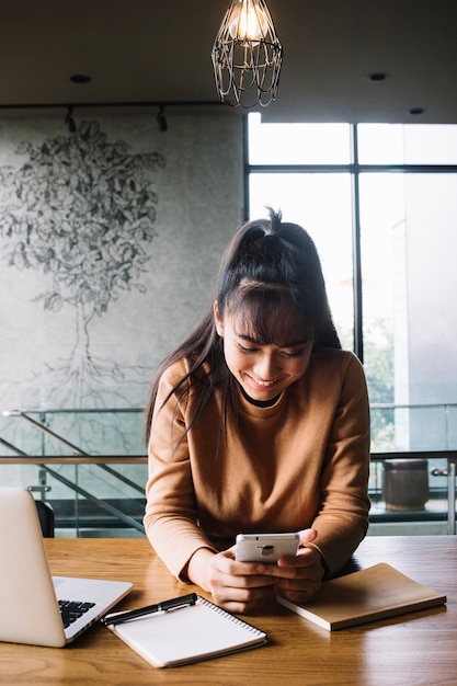 Free photo cheerful woman using phone