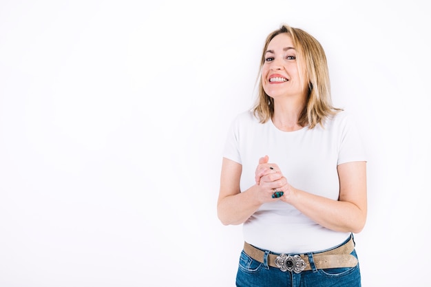 Cheerful woman with clasped hands