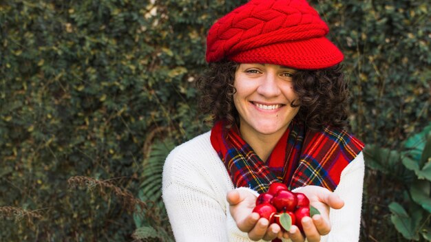 Cheerful woman with fake apples