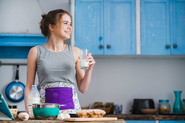 Cheerful woman with milk looking away