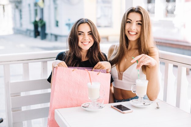 Cheerful woman with milkshakes