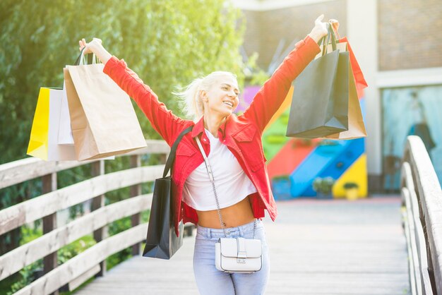 買い物のパケットを持つ陽気な女性