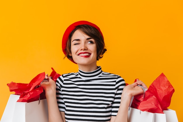 Free photo cheerful woman with store bags looking up with smile