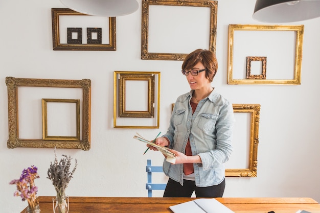 Cheerful woman working with a color palette