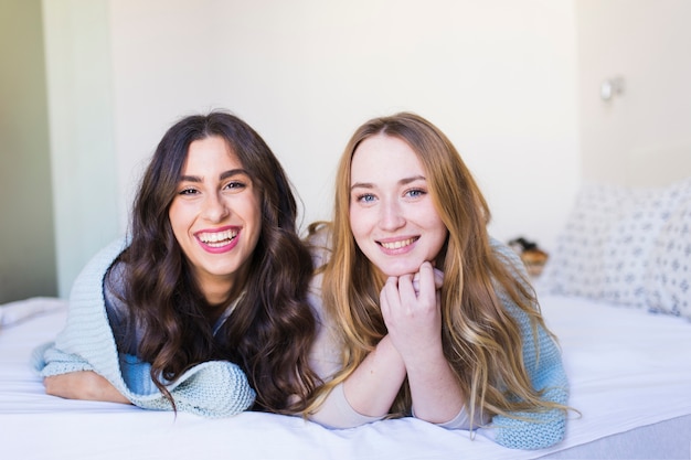 Cheerful women on bed