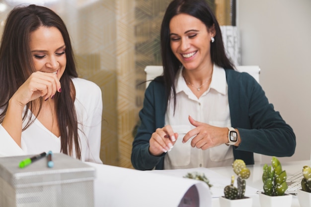 Cheerful women doing paperwork