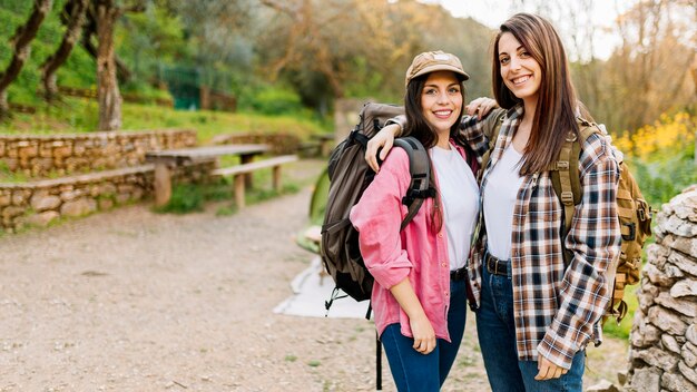 Cheerful women with backpacks