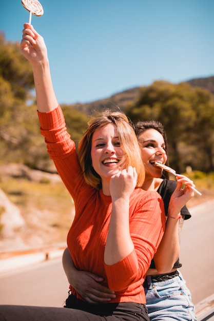 Free photo cheerful women with lollipops