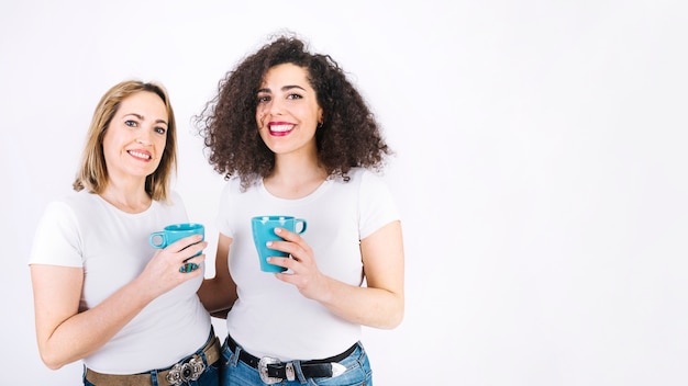 Cheerful women with mugs