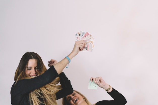 Cheerful women with playing cards