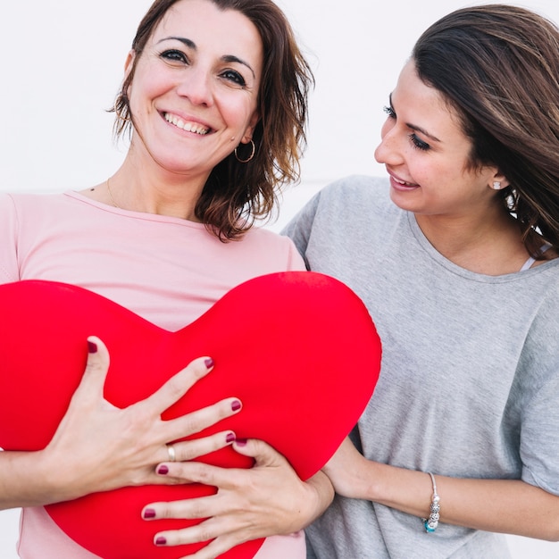 Cheerful women with plush heart