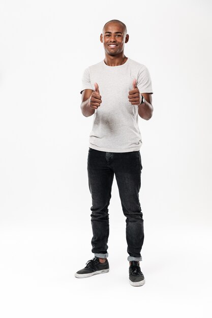 Cheerful young african man showing thumbs up.