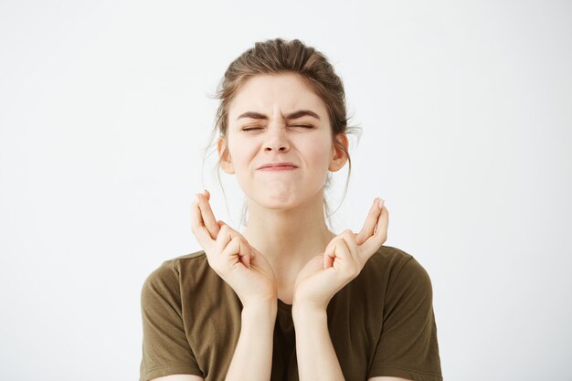 Cheerful young beautiful woman praying.