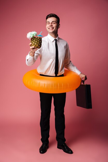 Cheerful young businessman with rubber ring