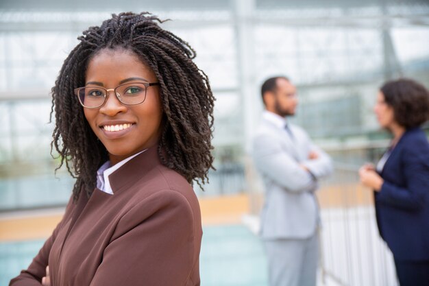 Cheerful young businesswoman in eyeglasses