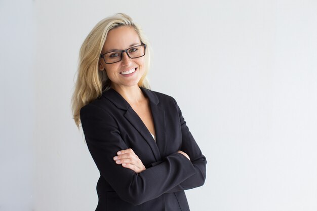 Cheerful young businesswoman wearing eyeglasses