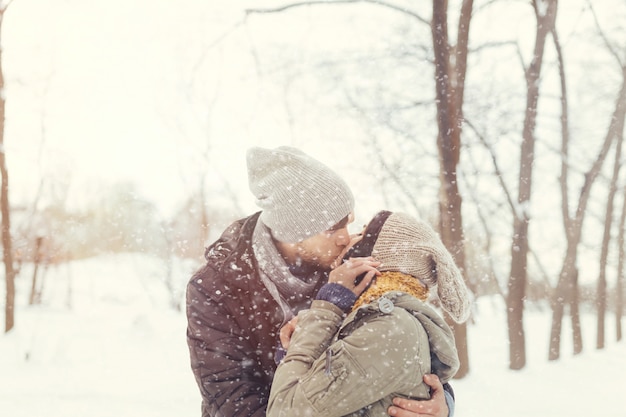 Free photo cheerful young couple walking in a winter day