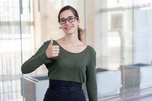 Cheerful young employee celebrating professional success