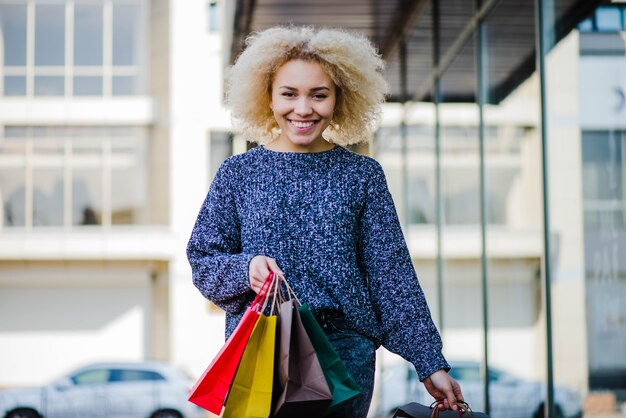 Cheerful young girl with purchases