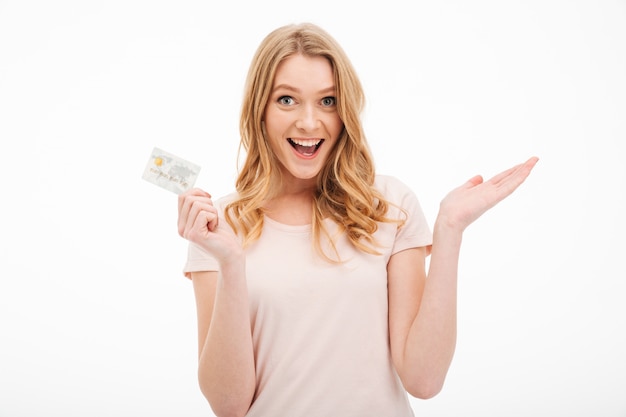 Cheerful young lady holding credit card.