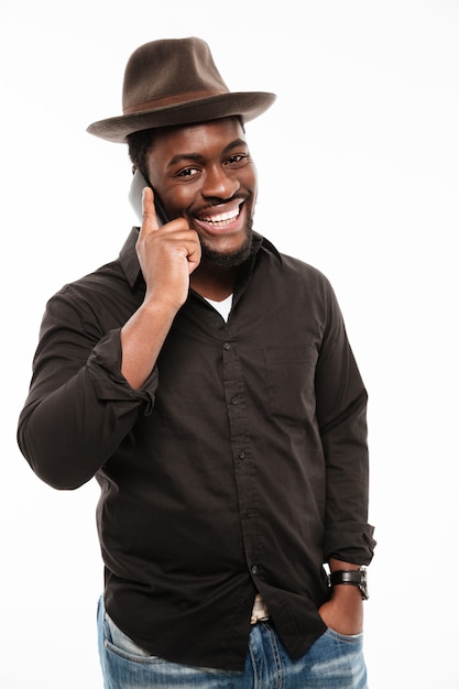 Cheerful young man talking by phone.