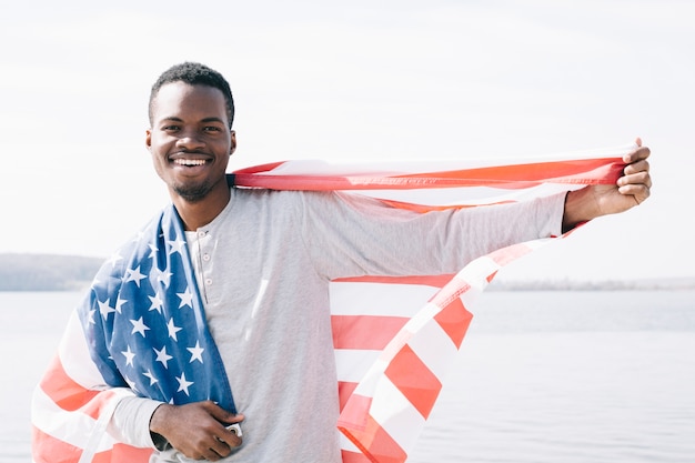 Cheerful young man with USA flag