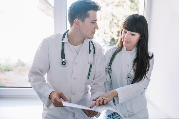 Cheerful young medics at window