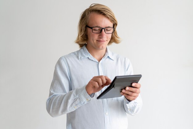 Cheerful young project leader calculating profit