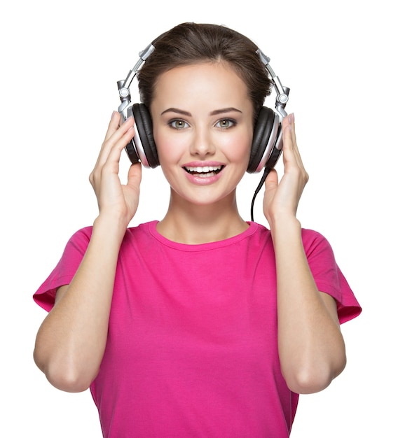 Free photo cheerful young woman listening music with headphones