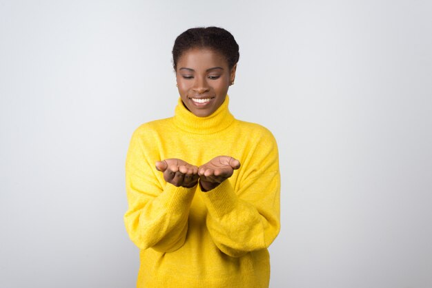 Cheerful young woman showing palms