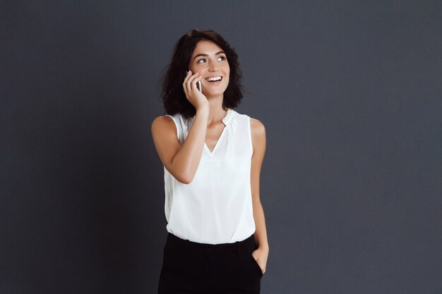 Cheerful young woman talking on her phone