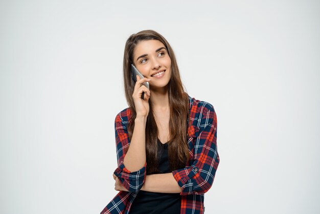 Cheerful young woman talking on mobile phone