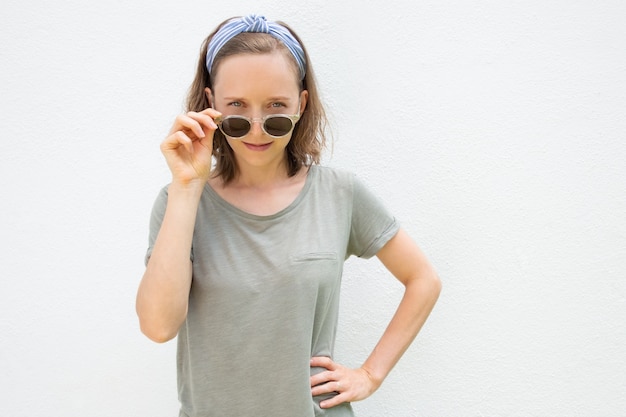 Cheerful young woman wearing hairband and summer clothes