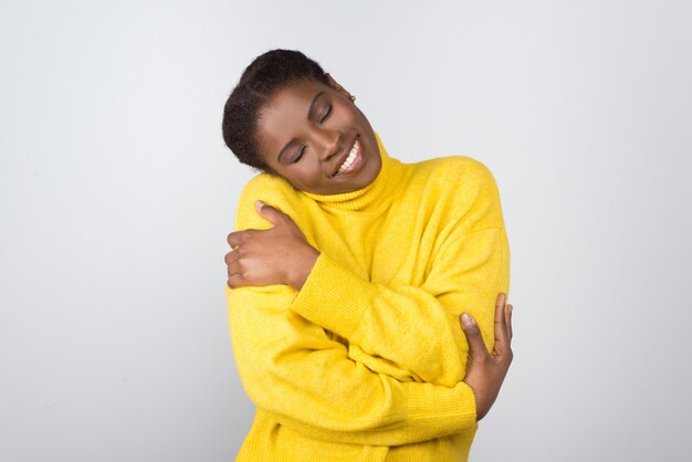 Cheerful young woman with closed eyes