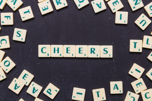 Cheers scrabble letters over black background