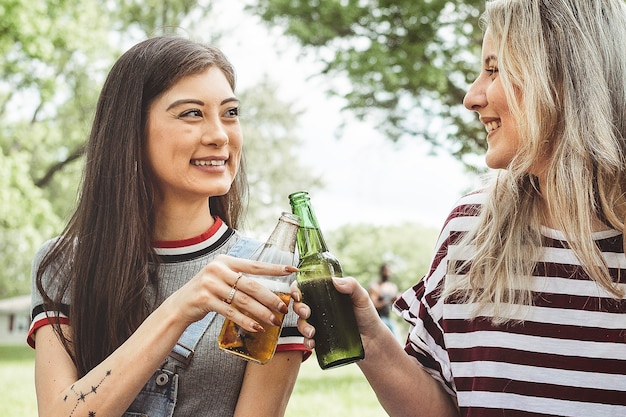 Cheers with beer at a summer party in the park