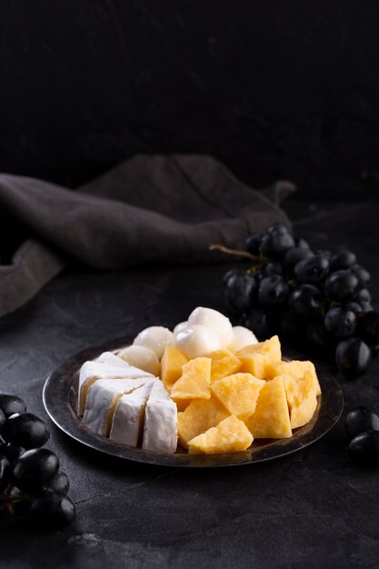 Cheese assortment with black grapes