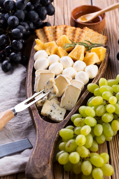 Cheese assortment with honey and grapes