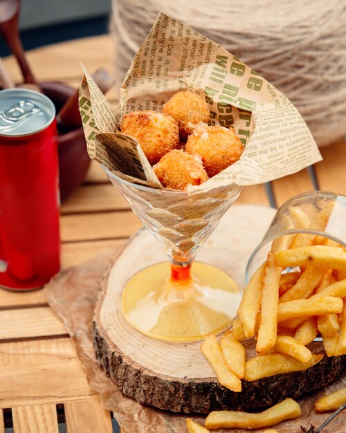 Cheese balls with french fries on the table