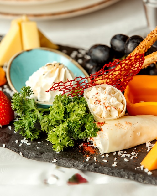 Cheese plate with crackers and grape